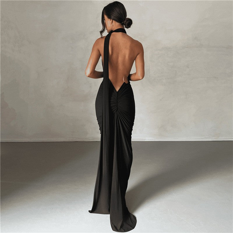 Summer women's fashionable backless, halter-neck, figure-hugging, curvaceous evening dress with a fitted bodice. Women's dress.