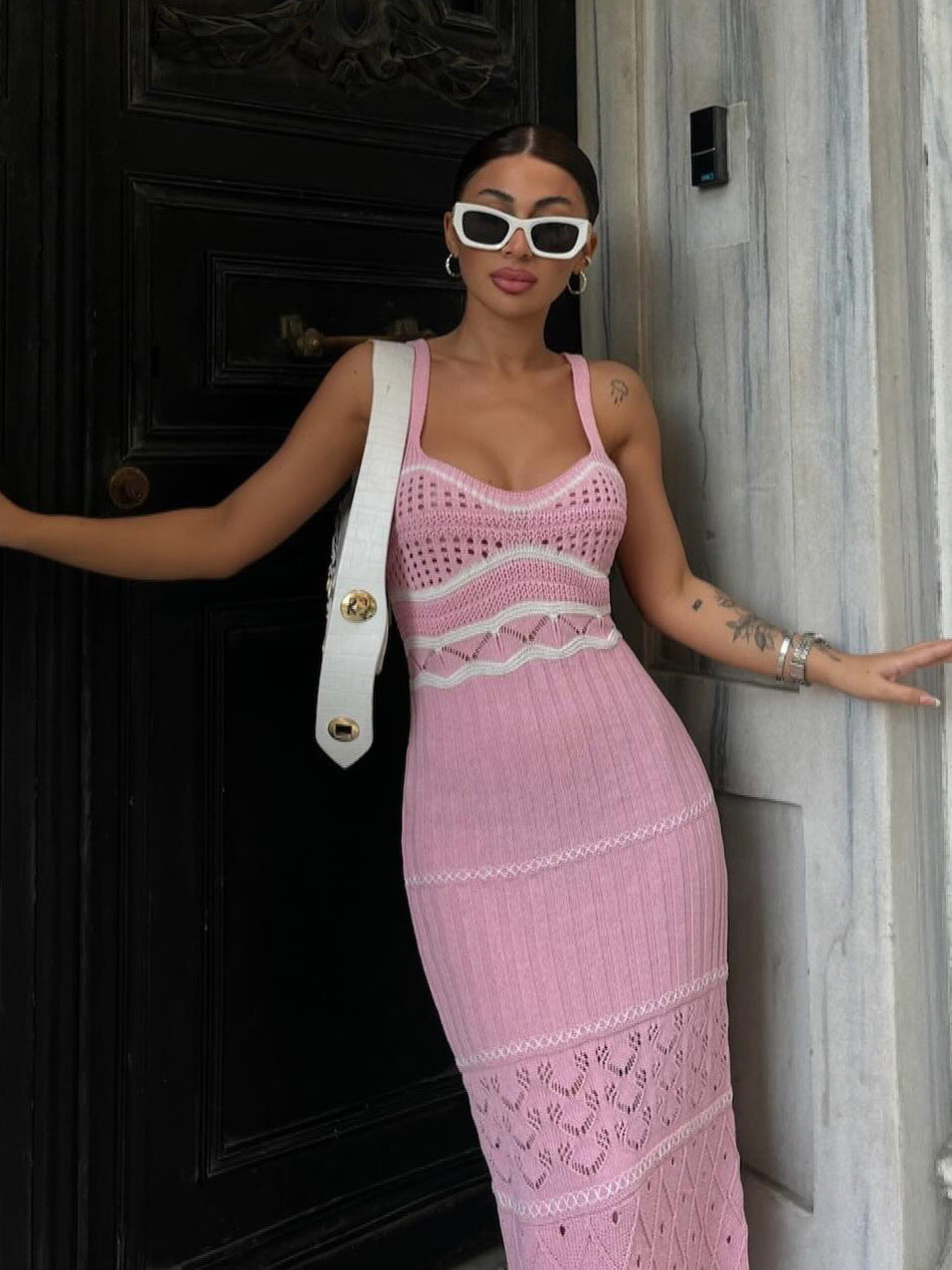 Women's halter top dress with a fitted and hourglass shape, showing off a slim figure. A mid-length, slit, fishtail-style dress. A feminine, bold look for women.