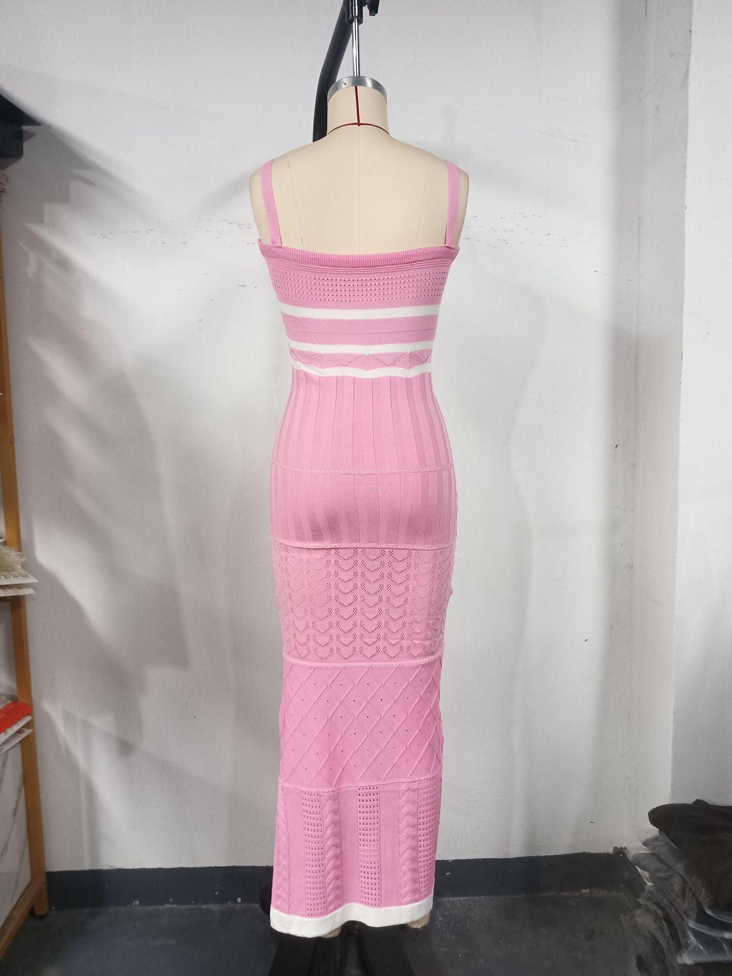 Women's halter top dress with a fitted and hourglass shape, showing off a slim figure. A mid-length, slit, fishtail-style dress. A feminine, bold look for women.