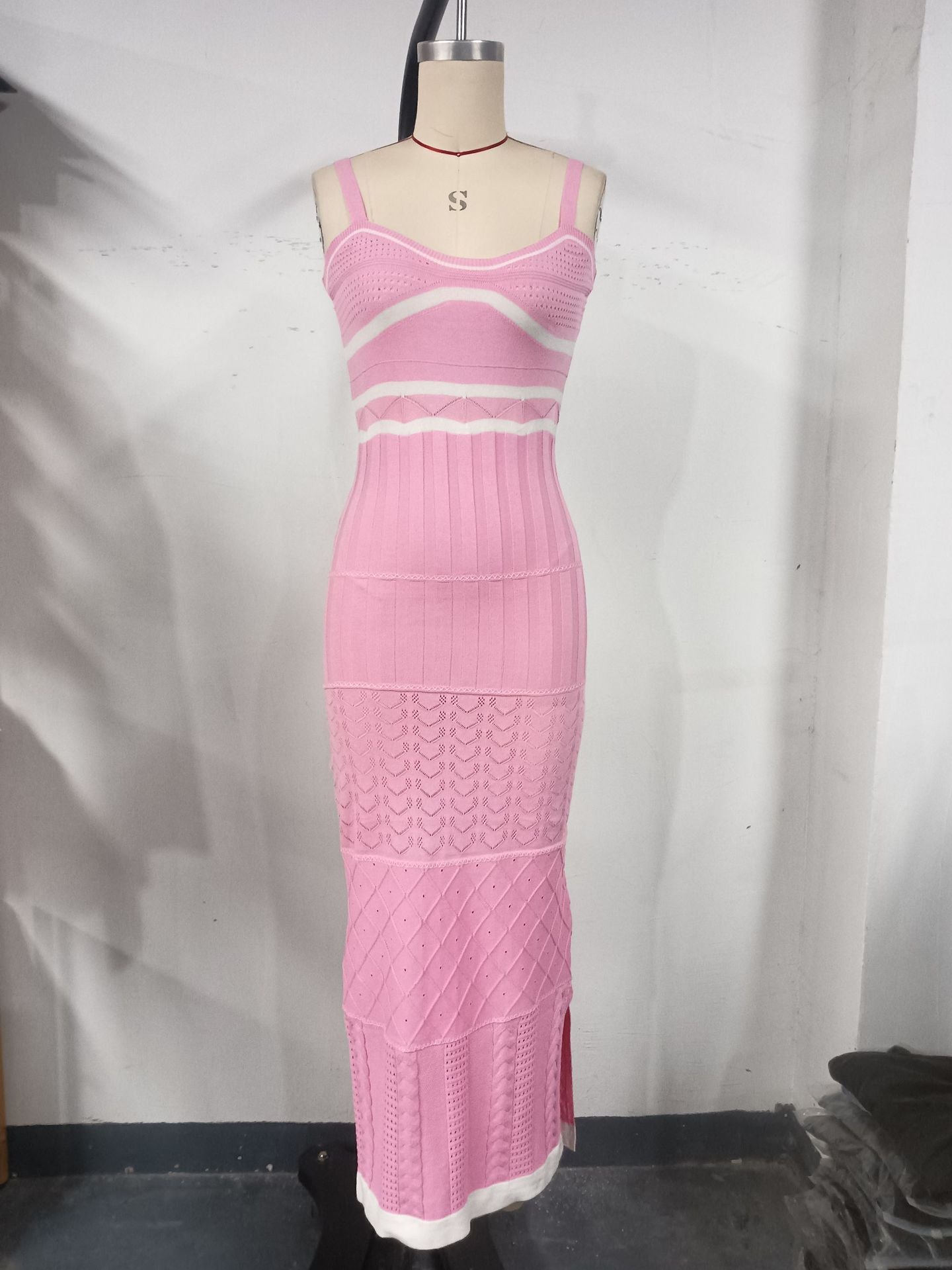 Women's halter top dress with a fitted and hourglass shape, showing off a slim figure. A mid-length, slit, fishtail-style dress. A feminine, bold look for women.