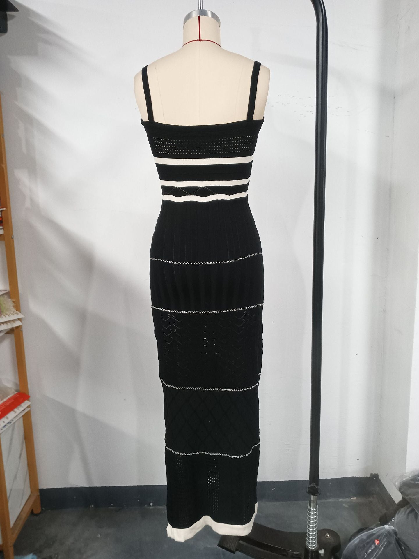 Women's halter top dress with a fitted and hourglass shape, showing off a slim figure. A mid-length, slit, fishtail-style dress. A feminine, bold look for women.