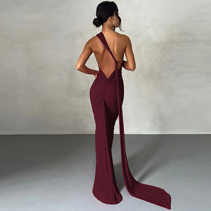 Summer women's fashionable backless, halter-neck, figure-hugging, curvaceous evening dress with a fitted bodice. Women's dress.