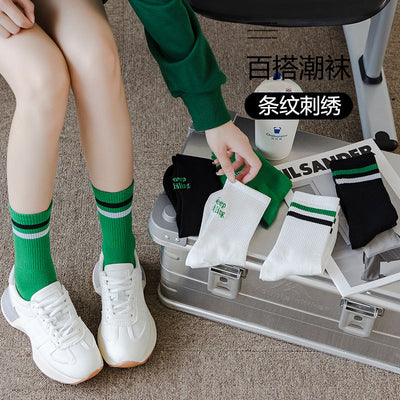 Sock children's winter and autumn ankle-length lettered tube socks in black and white. Women's cotton socks with letter embroidery. Two stripes.