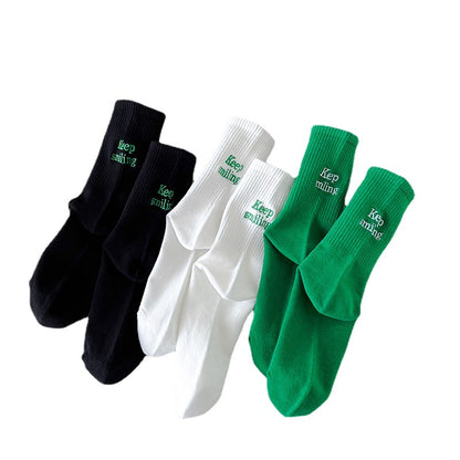 Sock children's winter and autumn ankle-length lettered tube socks in black and white. Women's cotton socks with letter embroidery. Two stripes.