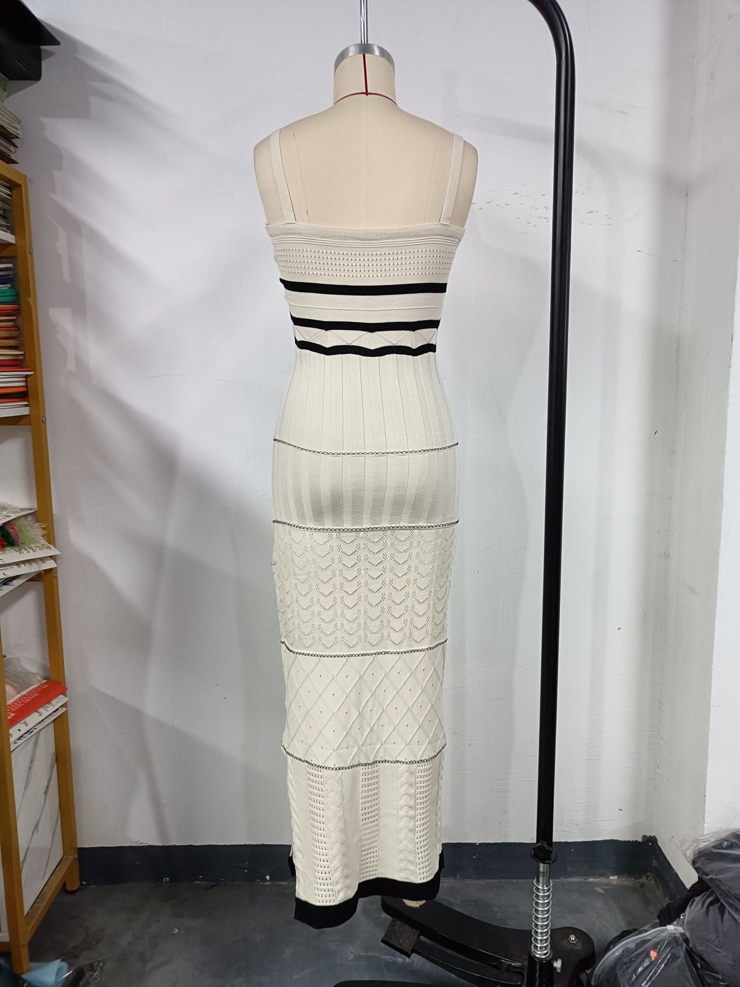 Women's halter top dress with a fitted and hourglass shape, showing off a slim figure. A mid-length, slit, fishtail-style dress. A feminine, bold look for women.