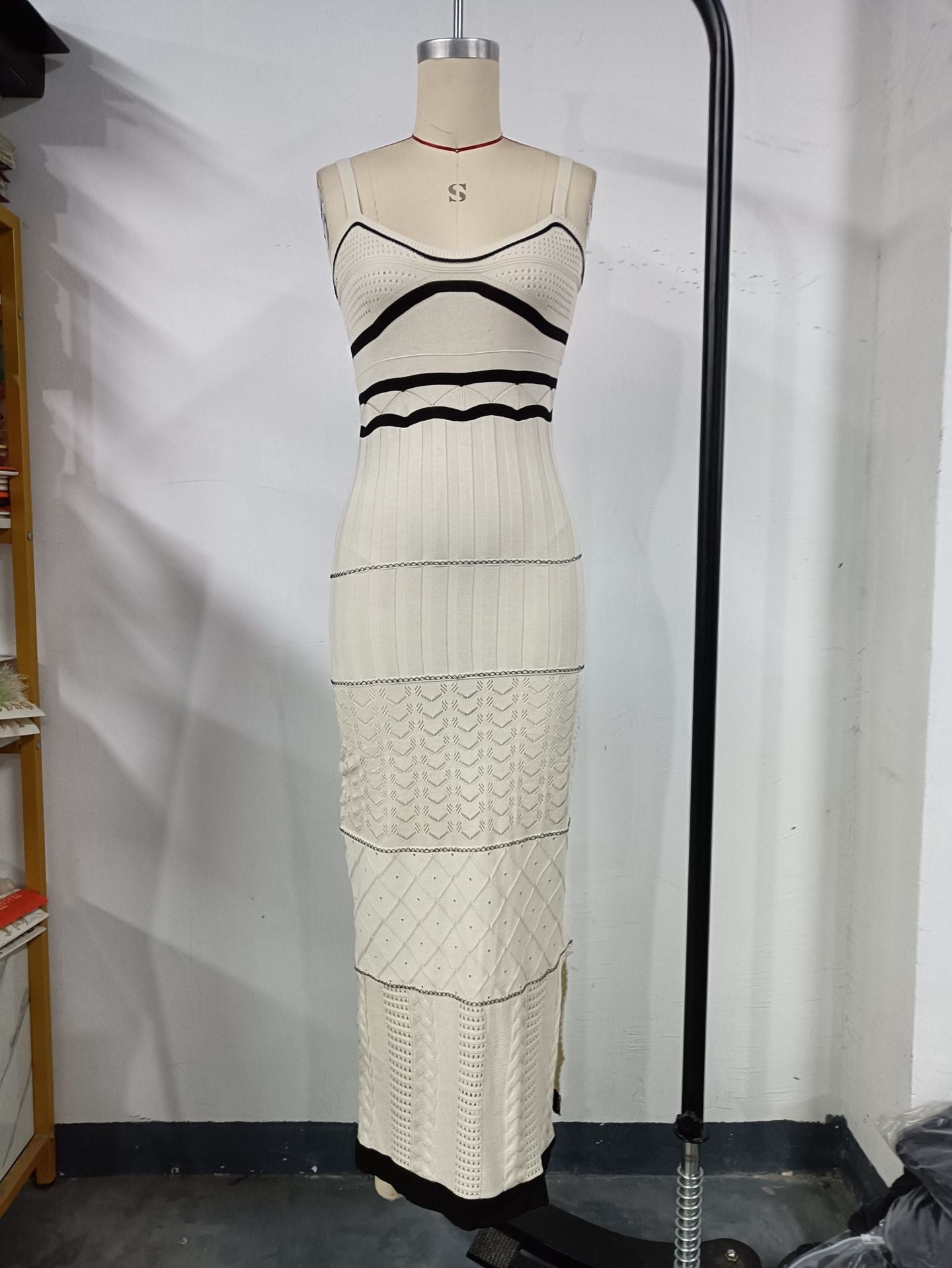 Women's halter top dress with a fitted and hourglass shape, showing off a slim figure. A mid-length, slit, fishtail-style dress. A feminine, bold look for women.
