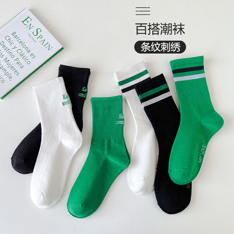 Sock children's winter and autumn ankle-length lettered tube socks in black and white. Women's cotton socks with letter embroidery. Two stripes.