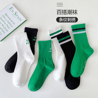 Sock children's winter and autumn ankle-length lettered tube socks in black and white. Women's cotton socks with letter embroidery. Two stripes.