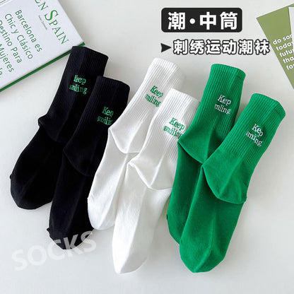 Sock children's winter and autumn ankle-length lettered tube socks in black and white. Women's cotton socks with letter embroidery. Two stripes.