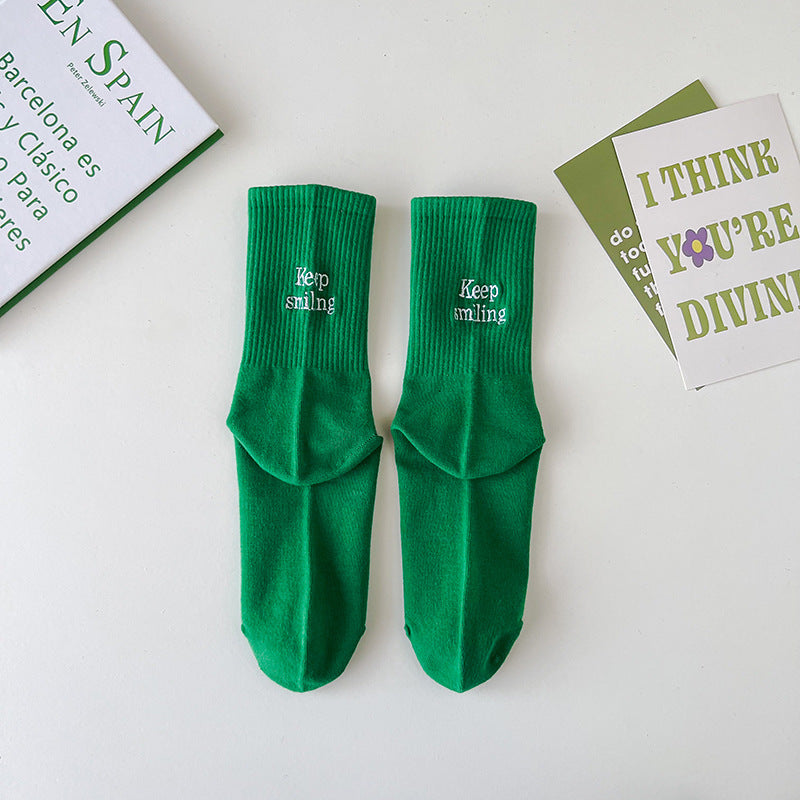 Sock children's winter and autumn ankle-length lettered tube socks in black and white. Women's cotton socks with letter embroidery. Two stripes.
