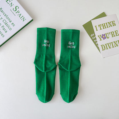 Sock children's winter and autumn ankle-length lettered tube socks in black and white. Women's cotton socks with letter embroidery. Two stripes.