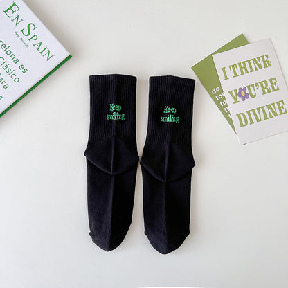 Sock children's winter and autumn ankle-length lettered tube socks in black and white. Women's cotton socks with letter embroidery. Two stripes.