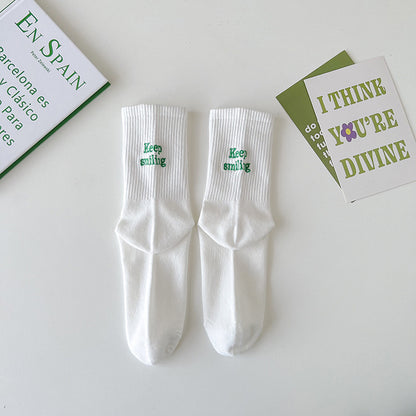 Sock children's winter and autumn ankle-length lettered tube socks in black and white. Women's cotton socks with letter embroidery. Two stripes.